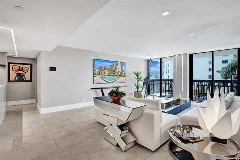 a living room with furniture and large windows