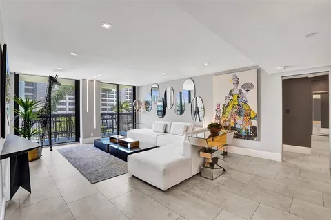 a living room with furniture a table and a potted plant