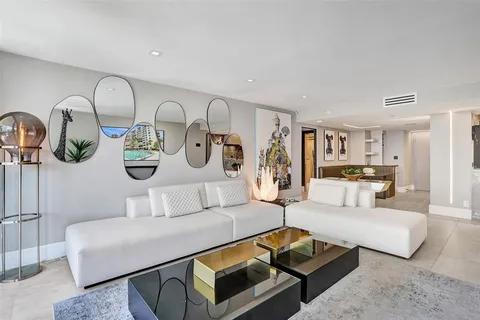 a living room with furniture and large windows