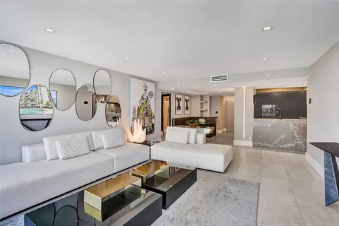 a bedroom with a bed and a large mirror