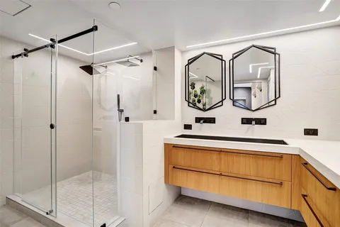 a bathroom with a double vanity sink and mirror