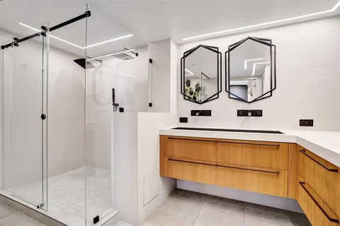 a bedroom with a large bed and a painting on the wall