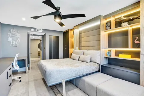 a living room with furniture and large windows