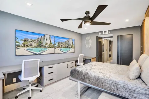 a living room with furniture and a painting on the wall