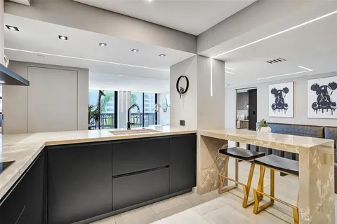 a kitchen with stainless steel appliances kitchen island granite countertop a sink and cabinets
