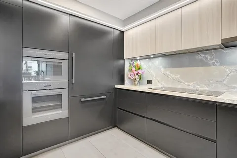 a kitchen with a sink and a mirror