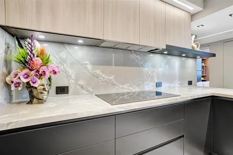 a kitchen with a sink a stove and chairs