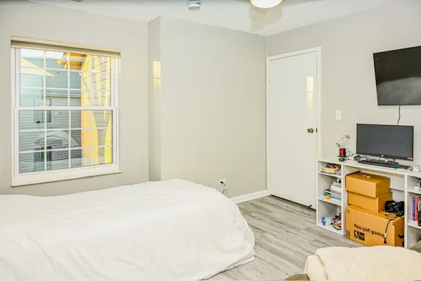a bedroom with a bed and flat screen tv