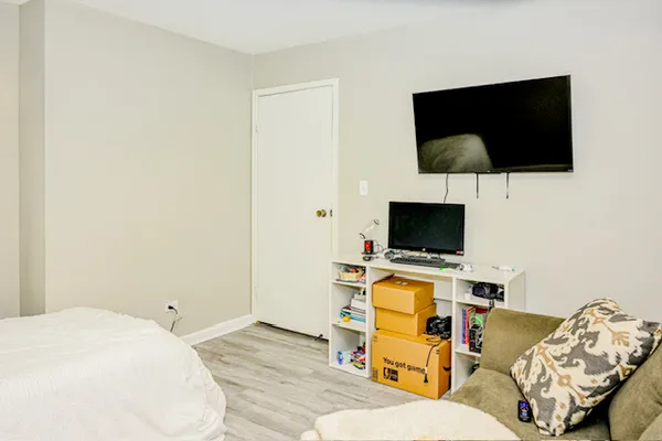 a bedroom with a bed and a flat screen tv