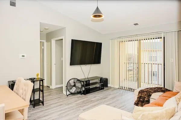 a bedroom with furniture and a flat screen tv