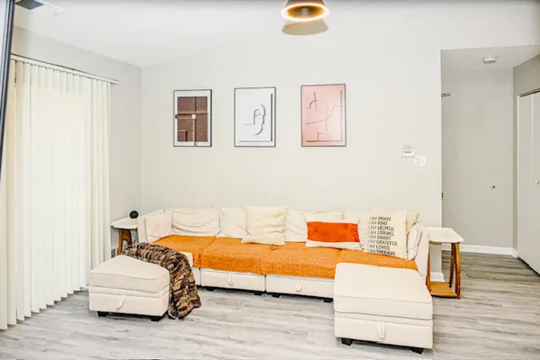 a bedroom with furniture and wooden floor