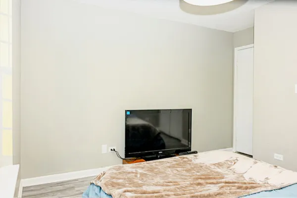 a bedroom with a bed and a flat screen tv