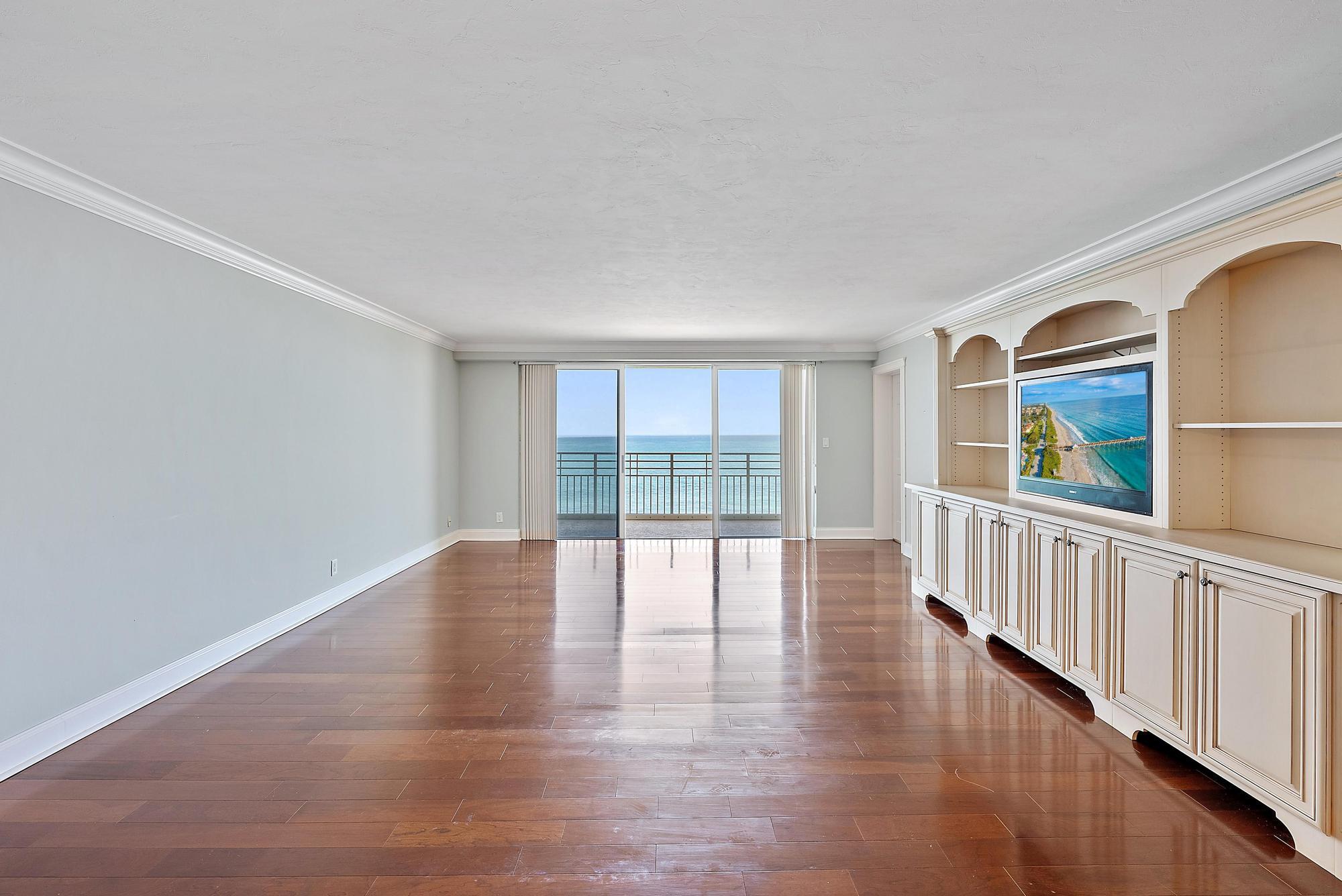 350 South Beach Road, Unit 503 Tequesta, FL 33469 - Photo 11 of 51 a view of an empty room with wooden floor and windows