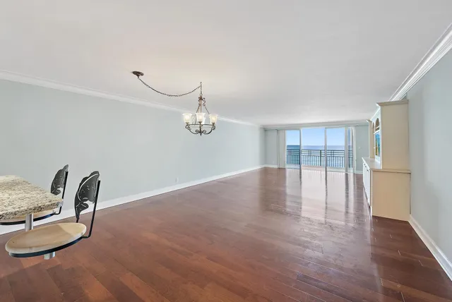 a view of a room with wooden floor and furniture