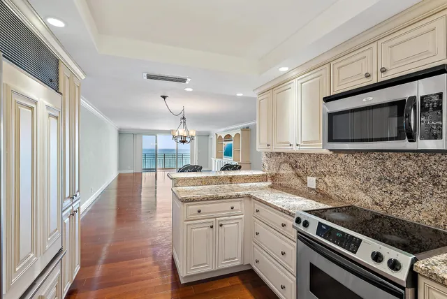 a kitchen with a sink stove and microwave