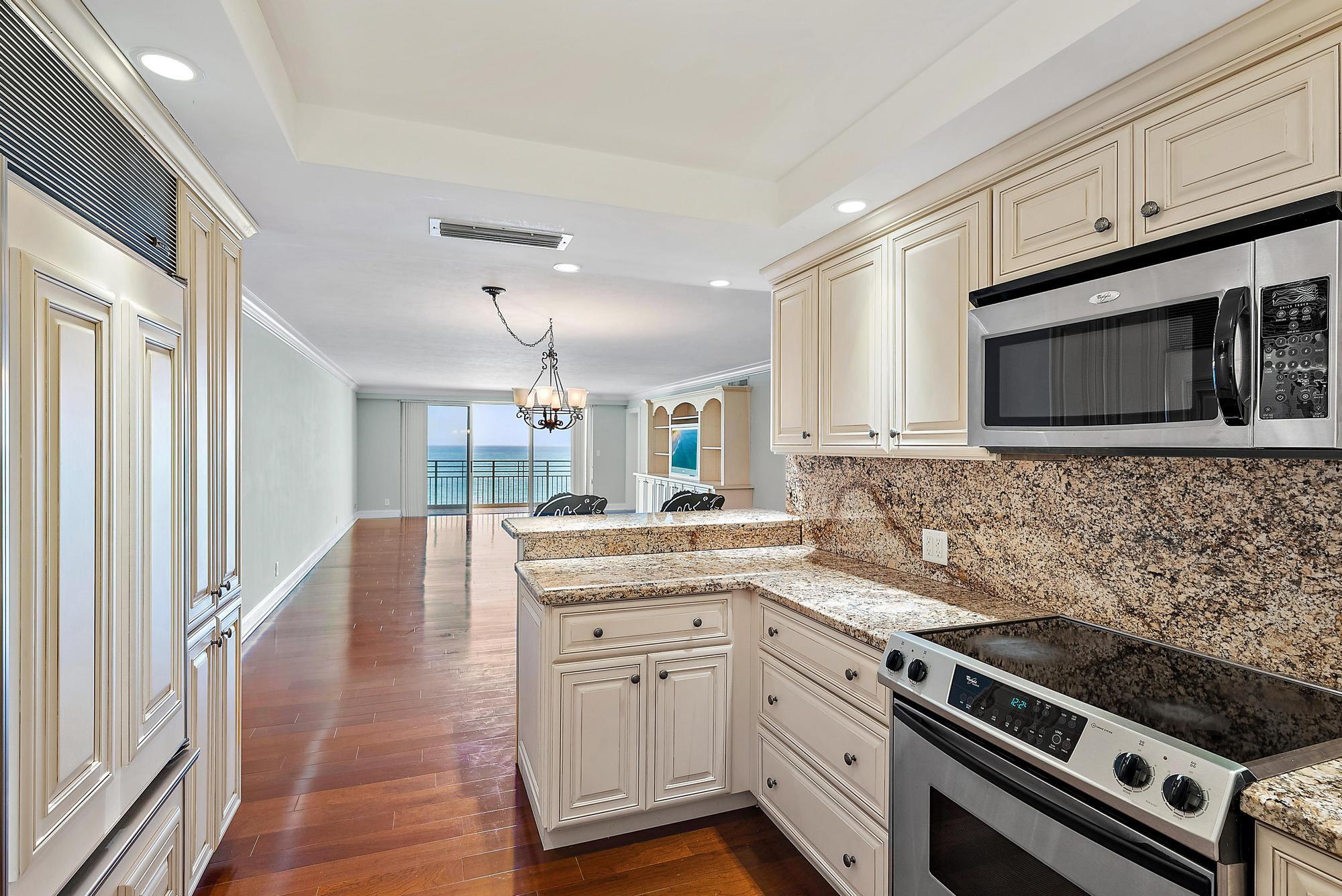 350 South Beach Road, Unit 503 Tequesta, FL 33469 - Photo 17 of 51 a kitchen with a sink stove and microwave