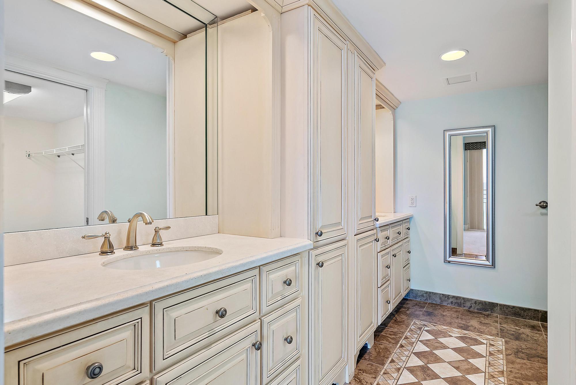 350 South Beach Road, Unit 503 Tequesta, FL 33469 - Photo 22 of 51 a bathroom with a granite countertop sink and a mirror