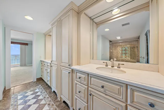 a spacious bathroom with a granite countertop sink and a mirror