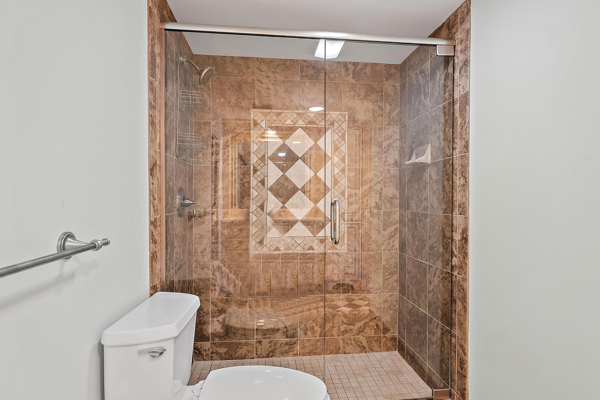 350 South Beach Road, Unit 503 Tequesta, FL 33469 - Photo 24 of 51 a bathroom with a shower curtain and a toilet