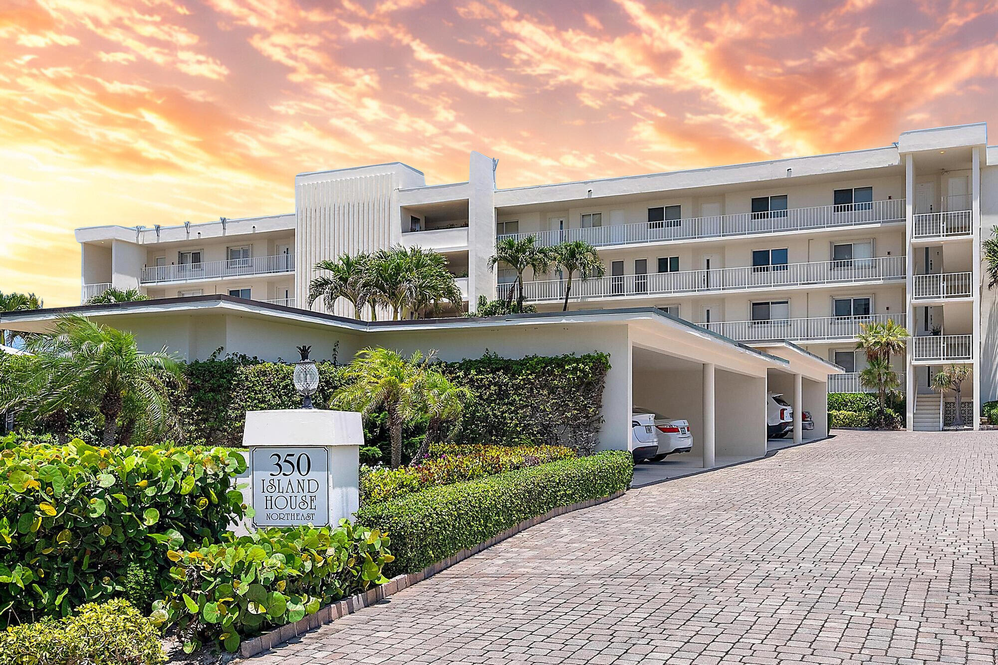 350 South Beach Road, Unit 503 Tequesta, FL 33469 - Photo 45 of 51 a front view of a house with a yard and potted plants