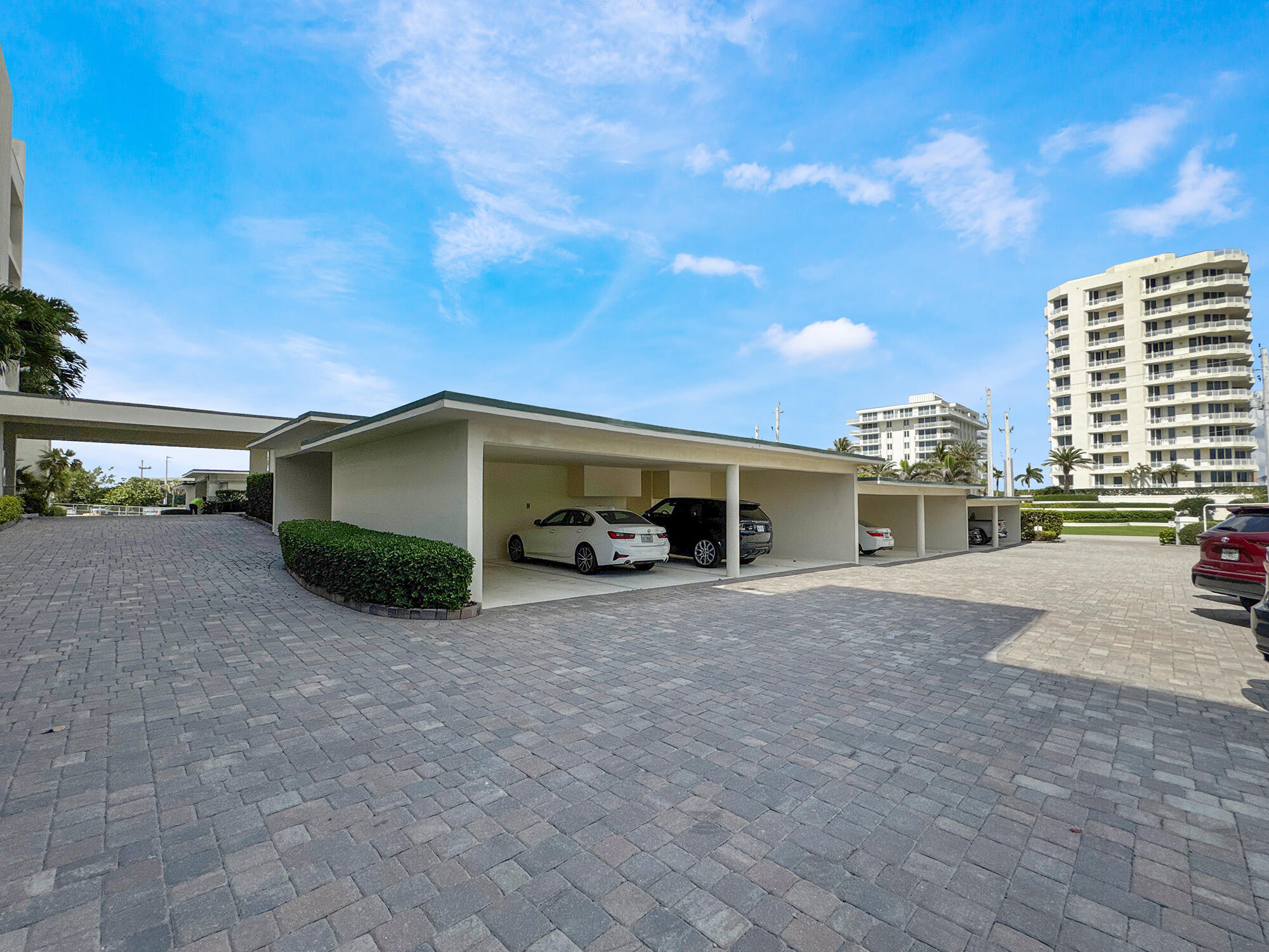 350 South Beach Road, Unit 503 Tequesta, FL 33469 - Photo 47 of 51 a front view of a house with a yard and garage