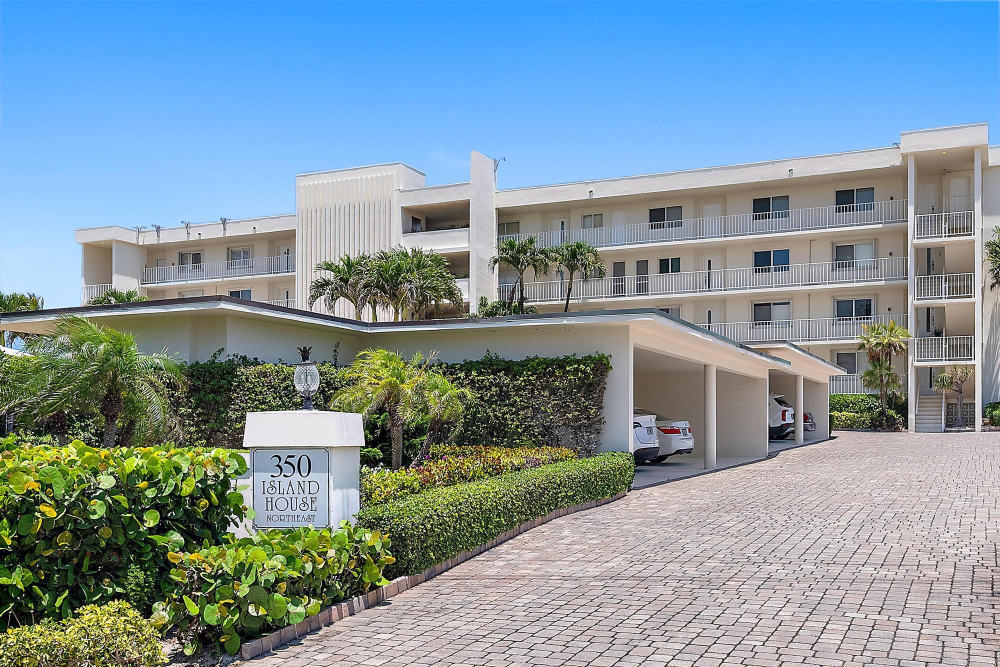 350 South Beach Road, Unit 503 Tequesta, FL 33469 - Photo 7 of 51 a front view of a building with a garden