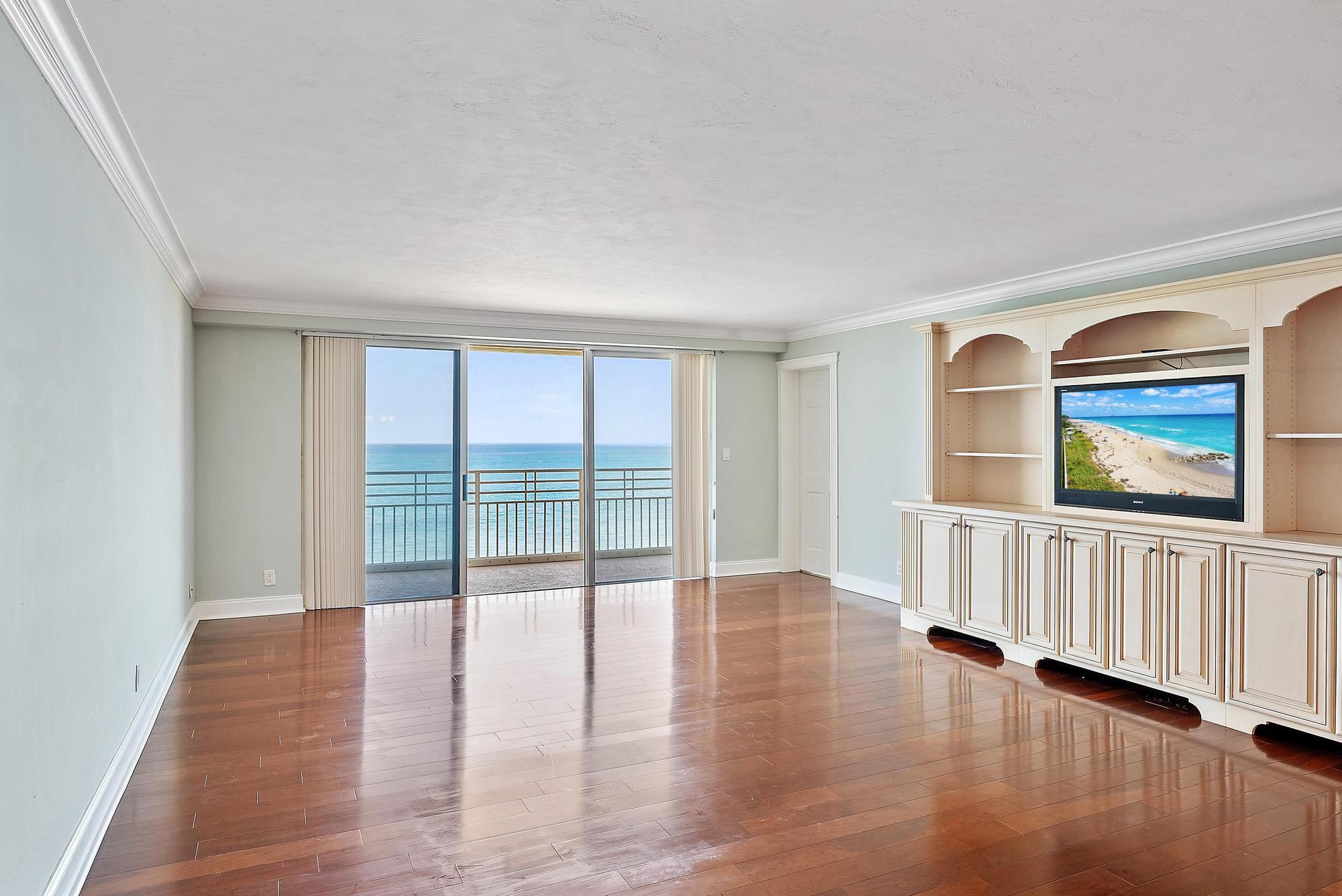 350 South Beach Road, Unit 503 Tequesta, FL 33469 - Photo 10 of 51 a view of an empty room with wooden floor and windows