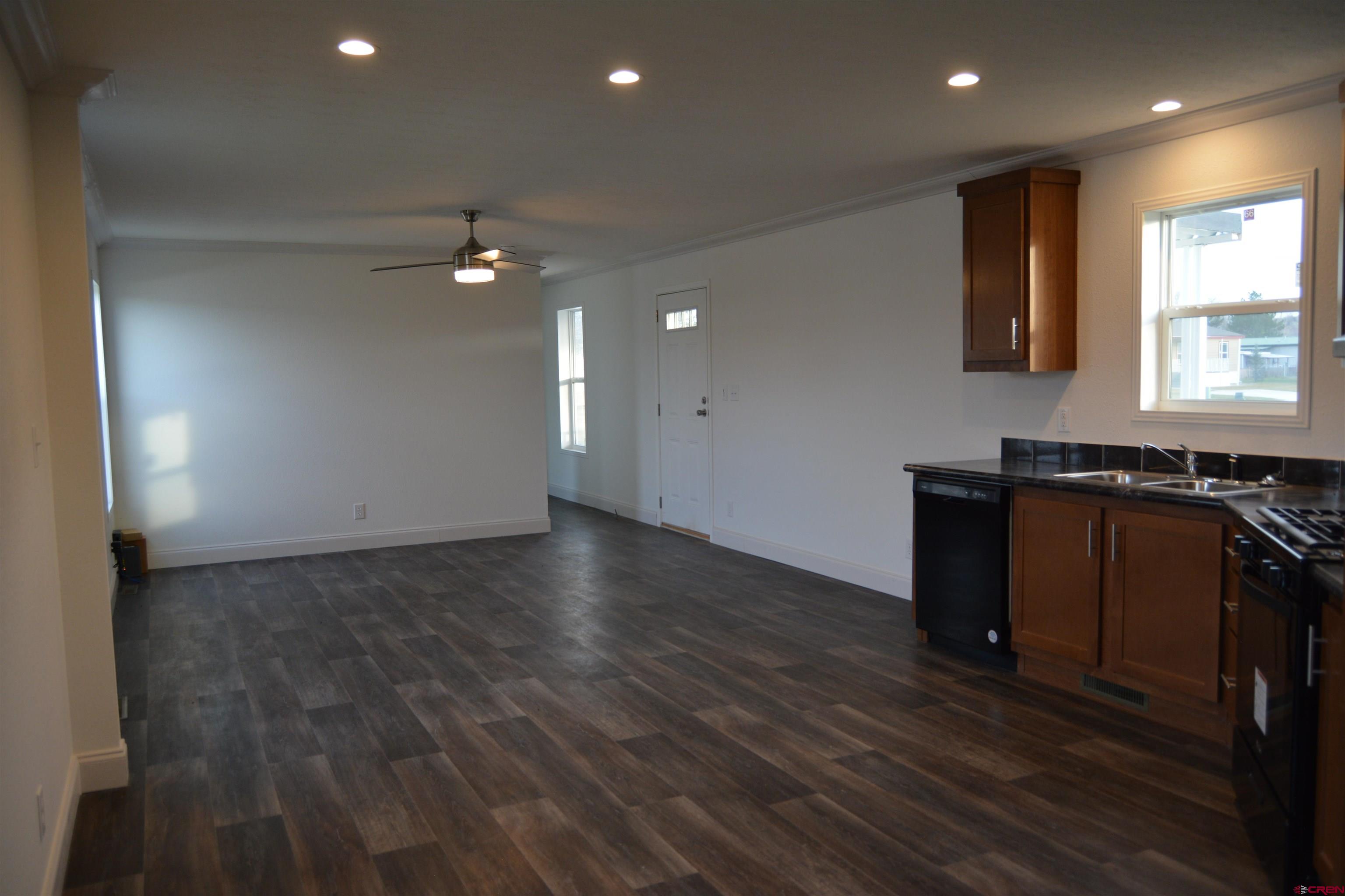 62650 Lasalle Road, Unit 811 Montrose, CO 81403 - Photo 4 of 12 wooden floor in an empty room with a window
