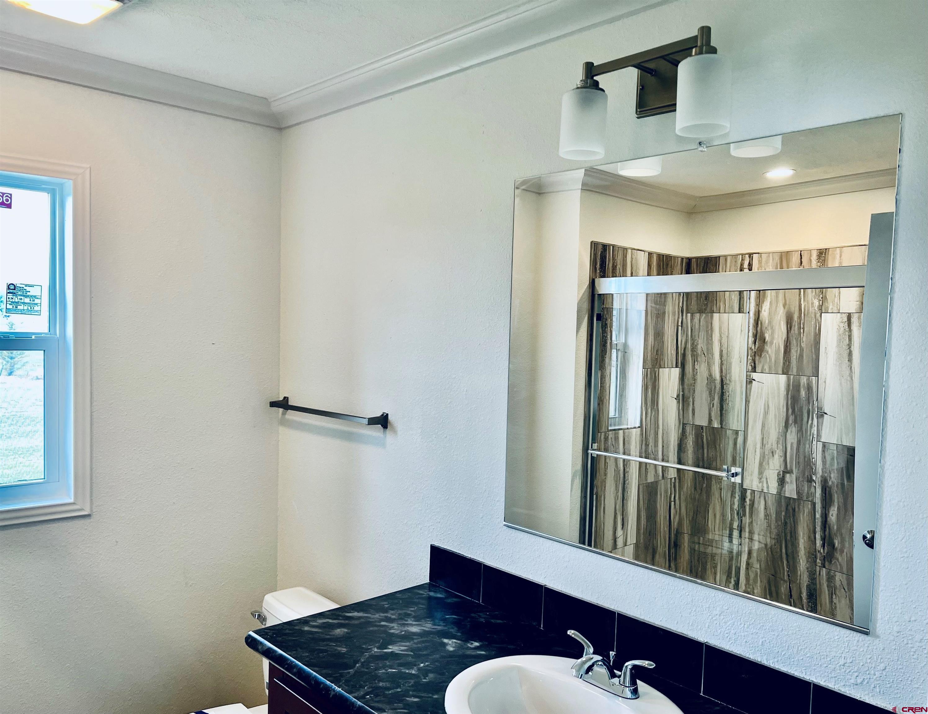 62650 Lasalle Road, Unit 811 Montrose, CO 81403 - Photo 6 of 12 a bathroom with a sink and mirror