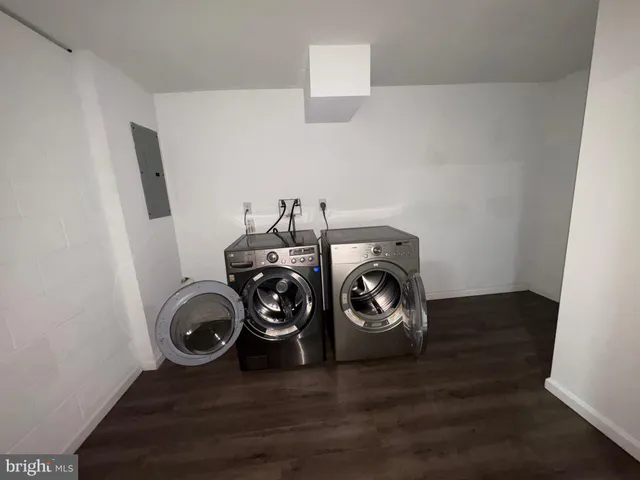 a view of storage and utility room with wooden floor