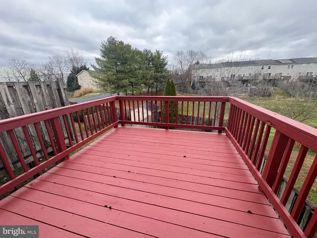 a balcony with wooden floor in city