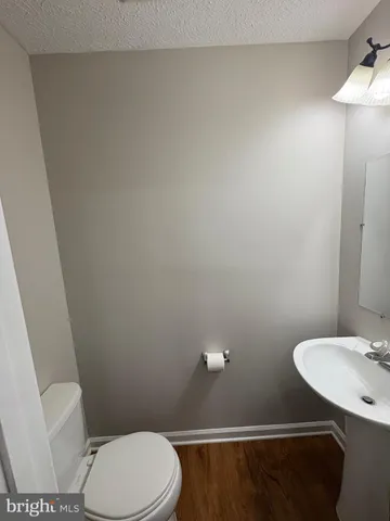 a white toilet sitting next to a bathroom sink