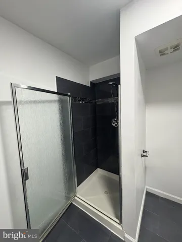 a bathroom with a glass shower door