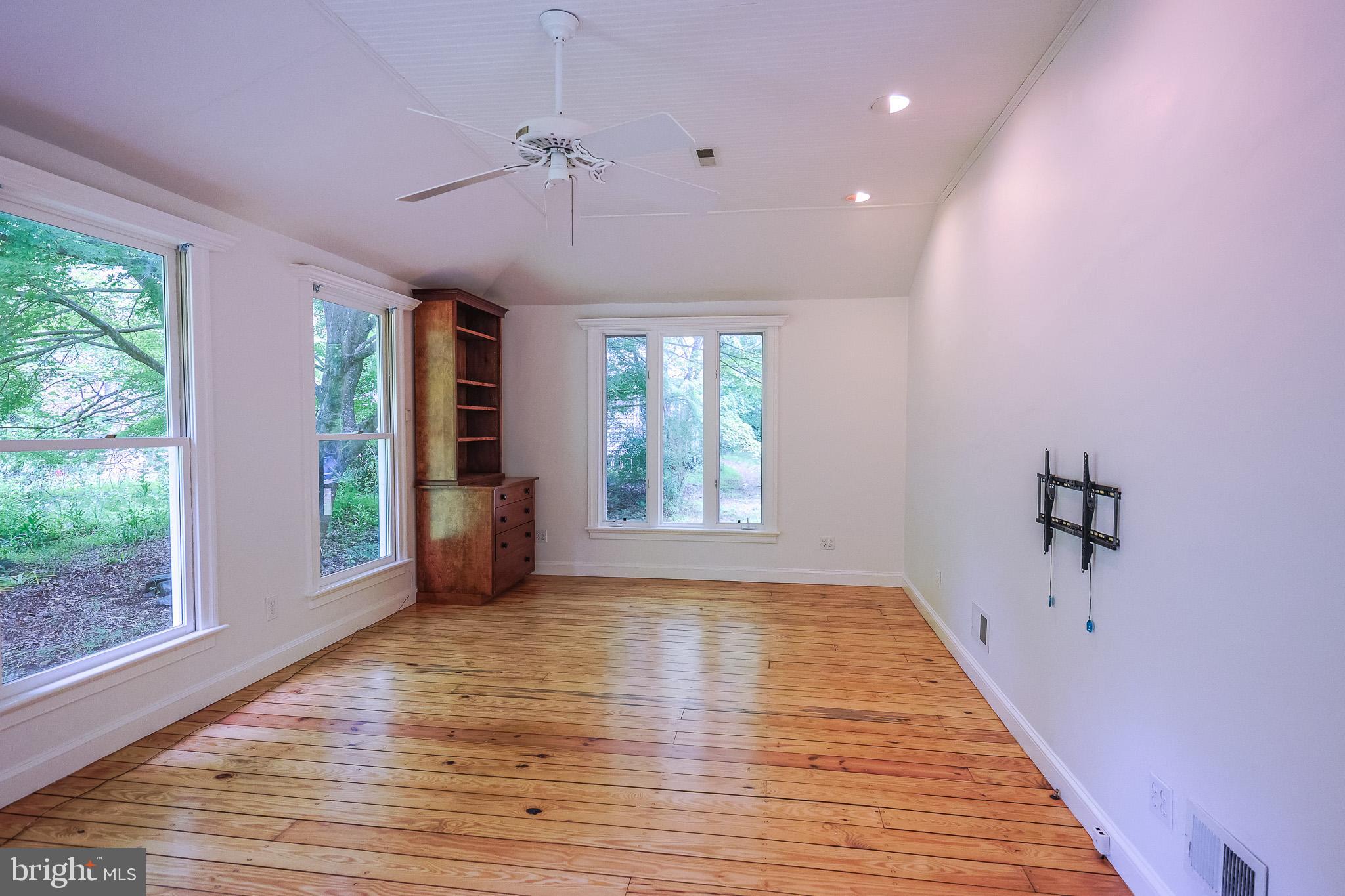 98 Swindler Hollow Road Sperryville, VA 22740 - Photo 16 of 25 a view of an empty room with a window and wooden floor