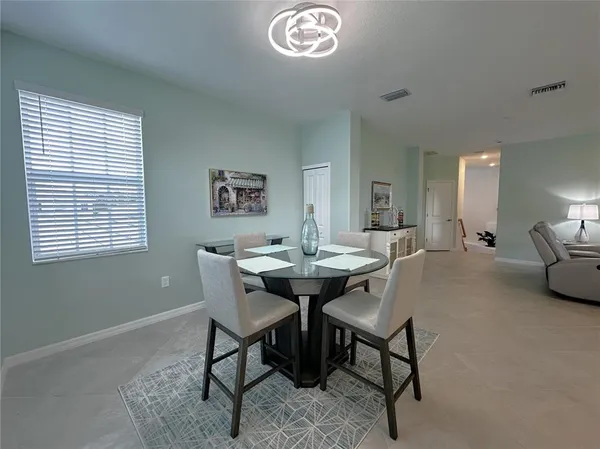 a view of a dining room with furniture and a chandelier