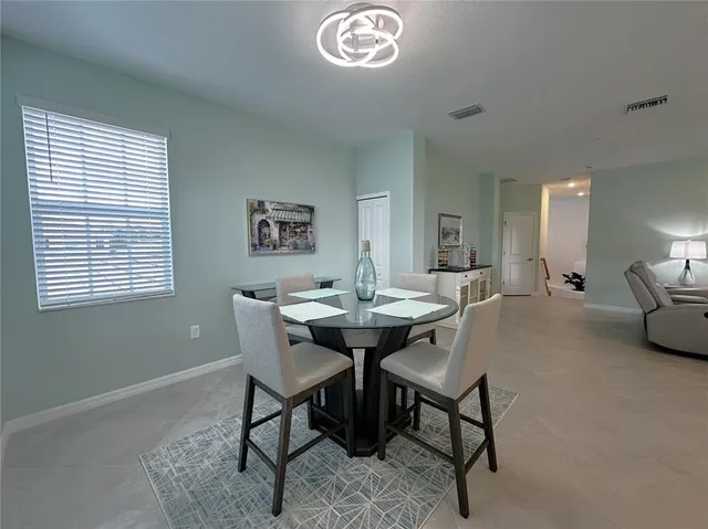 a view of a dining room with furniture and a chandelier