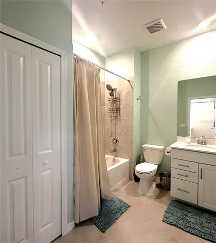 a bathroom with a toilet a sink and a large mirror