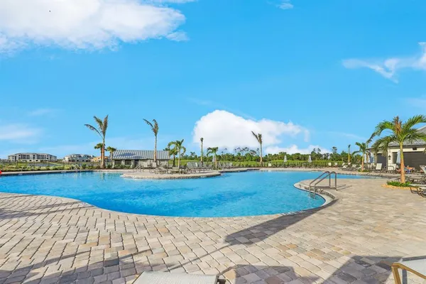 a view of a swimming pool and lounge chairs