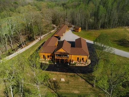 a dining hall with stainless steel appliances granite countertop a sink and a granite counter tops with a large window