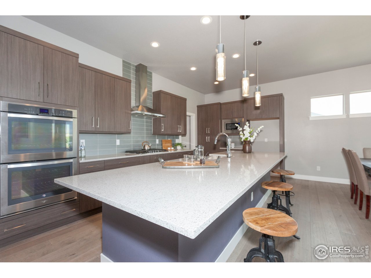 3818 Bridle Ridge Circle Fort Collins, CO 80524 - Photo 10 of 40 a kitchen with kitchen island a stove a table and chairs