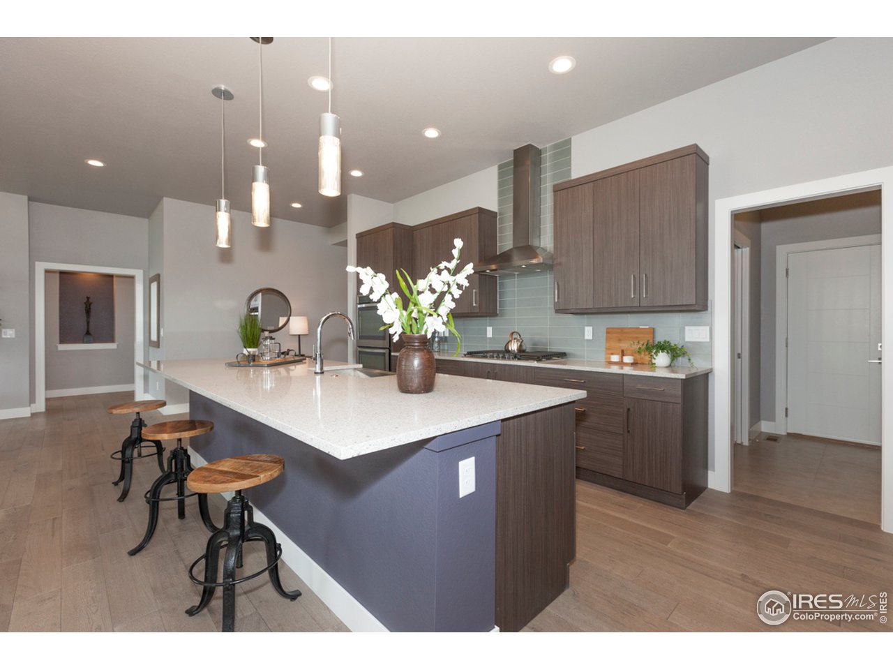 3818 Bridle Ridge Circle Fort Collins, CO 80524 - Photo 13 of 40 a kitchen with kitchen island a counter top space a sink stainless steel appliances and cabinets