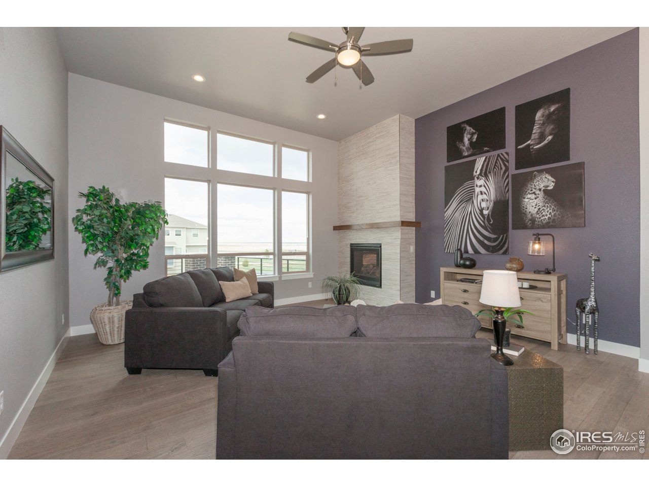 3818 Bridle Ridge Circle Fort Collins, CO 80524 - Photo 17 of 40 a living room with furniture a large window and a flat screen tv