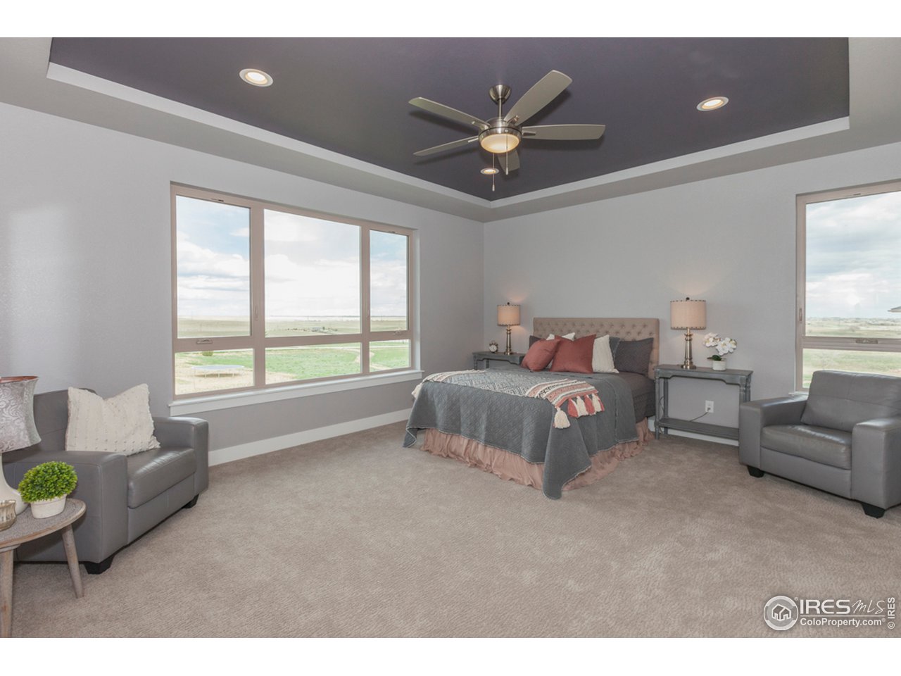 3818 Bridle Ridge Circle Fort Collins, CO 80524 - Photo 21 of 40 a spacious bedroom with a bed and a couch