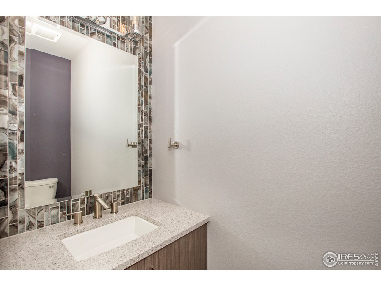 3818 Bridle Ridge Circle Fort Collins, CO 80524 - Photo 30 of 40 a bathroom with a sink and a mirror