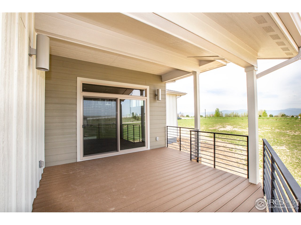 3818 Bridle Ridge Circle Fort Collins, CO 80524 - Photo 31 of 40 a view of an empty room with wooden floor and iron stairs