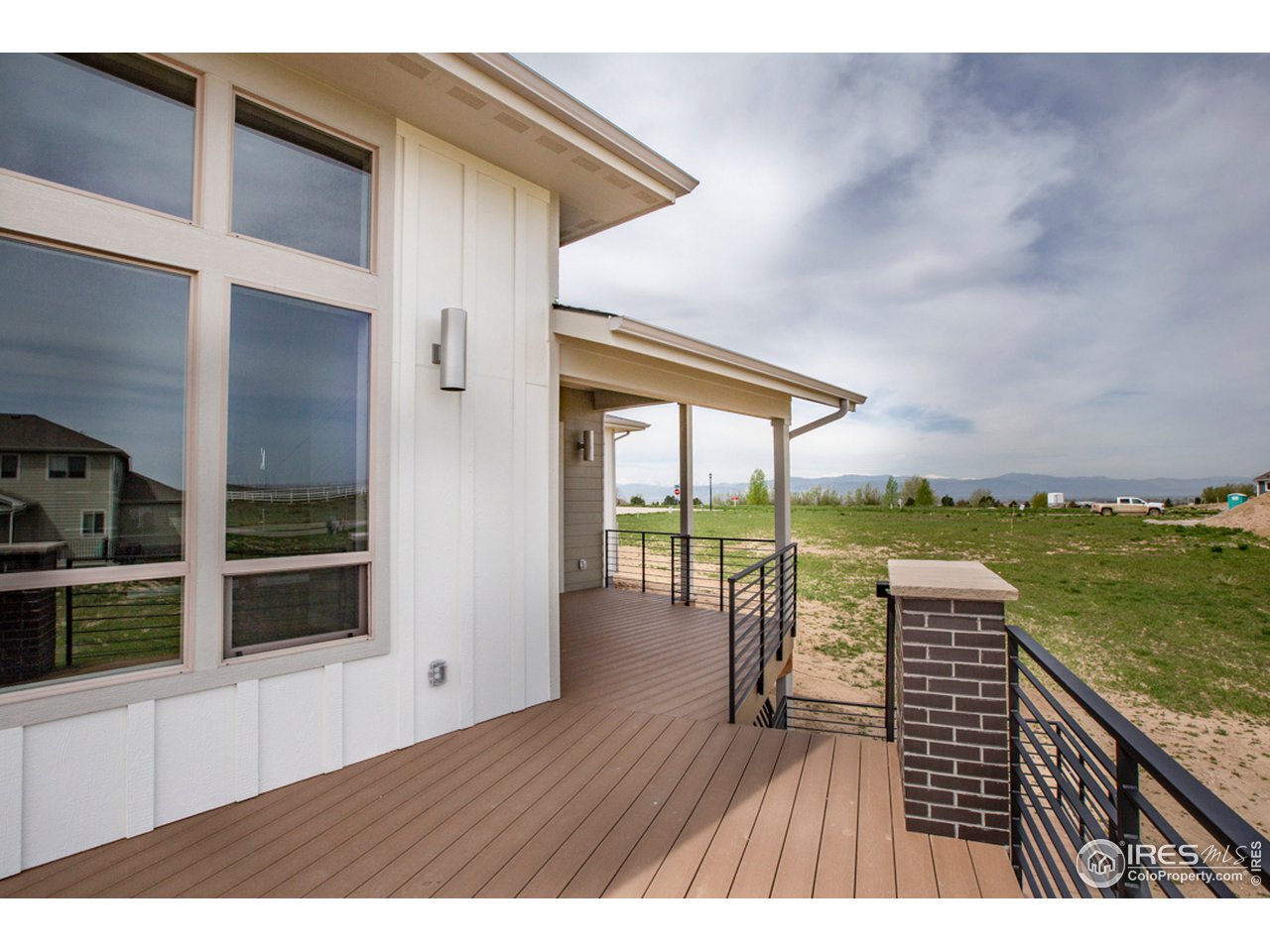 3818 Bridle Ridge Circle Fort Collins, CO 80524 - Photo 34 of 40 a view of a balcony with floor to ceiling windows with wooden floor