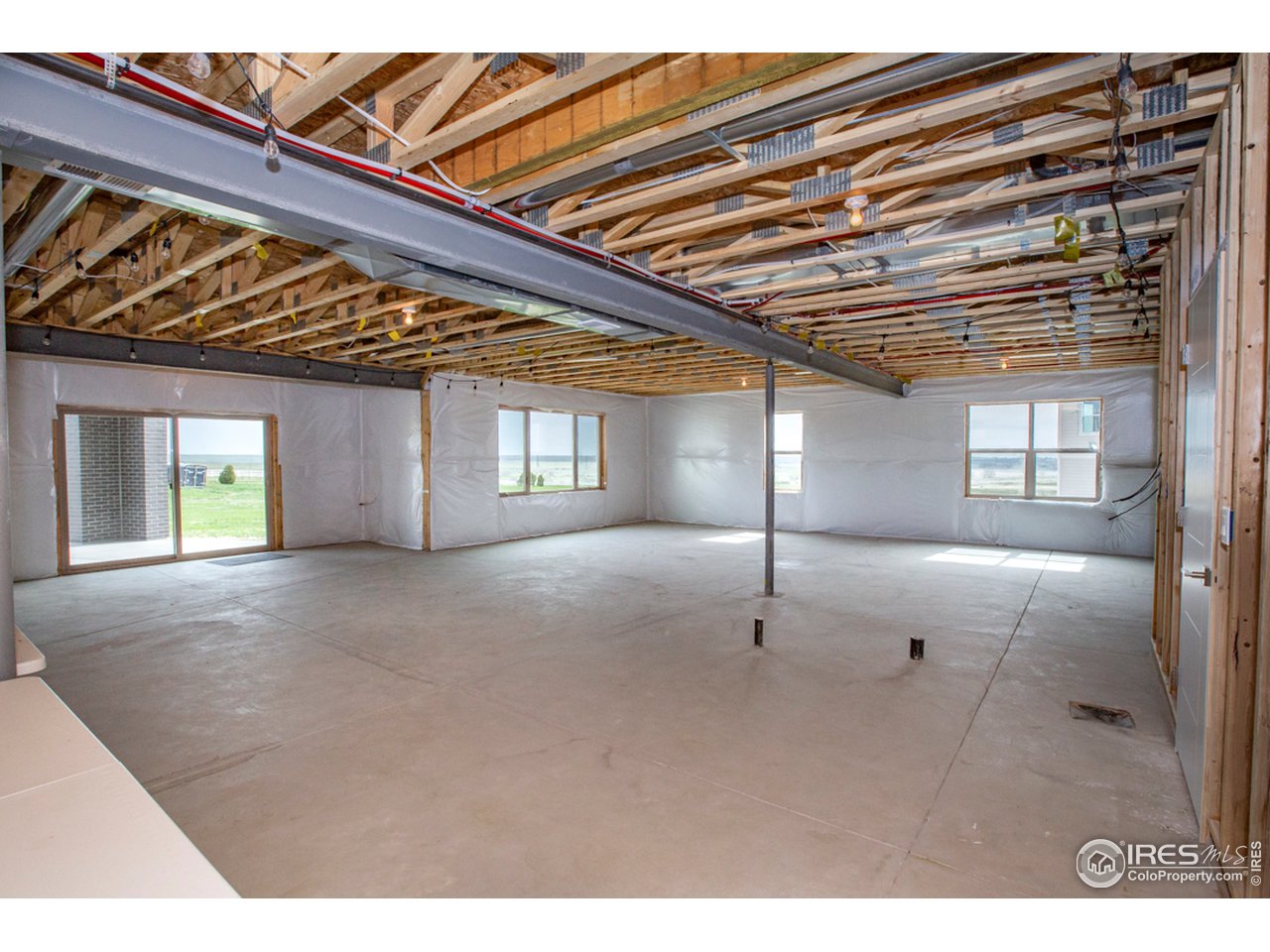 3818 Bridle Ridge Circle Fort Collins, CO 80524 - Photo 35 of 40 a view of a room with wooden floor and windows