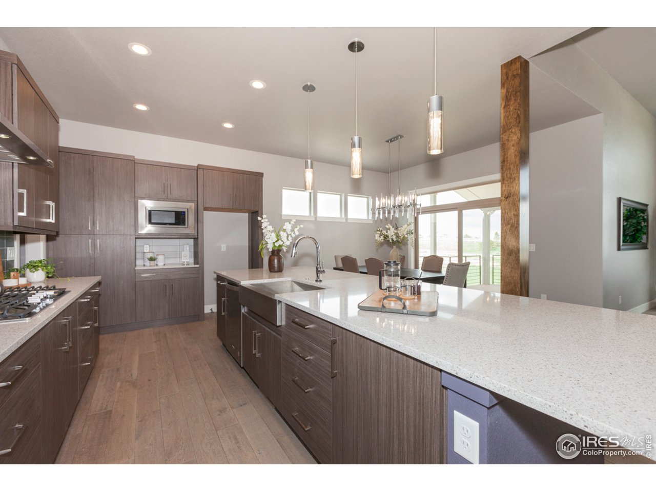 3818 Bridle Ridge Circle Fort Collins, CO 80524 - Photo 7 of 40 a kitchen with stainless steel appliances kitchen island granite countertop a sink refrigerator and cabinets