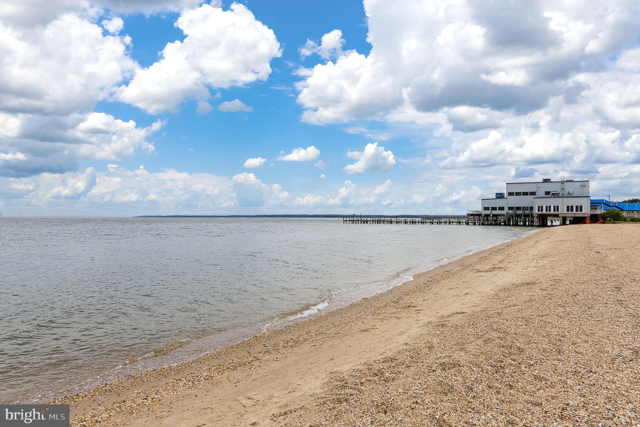 316 9th Street Colonial Beach, VA 22443 - Photo 39 of 63 Serene beach with clouds and pier view.