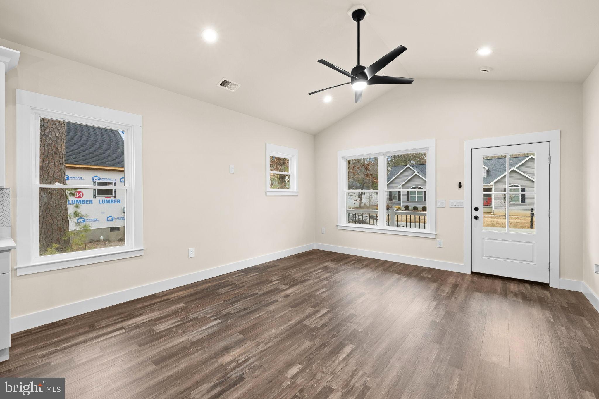 316 9th Street Colonial Beach, VA 22443 - Photo 51 of 59 a view of an empty room with wooden floor and a window